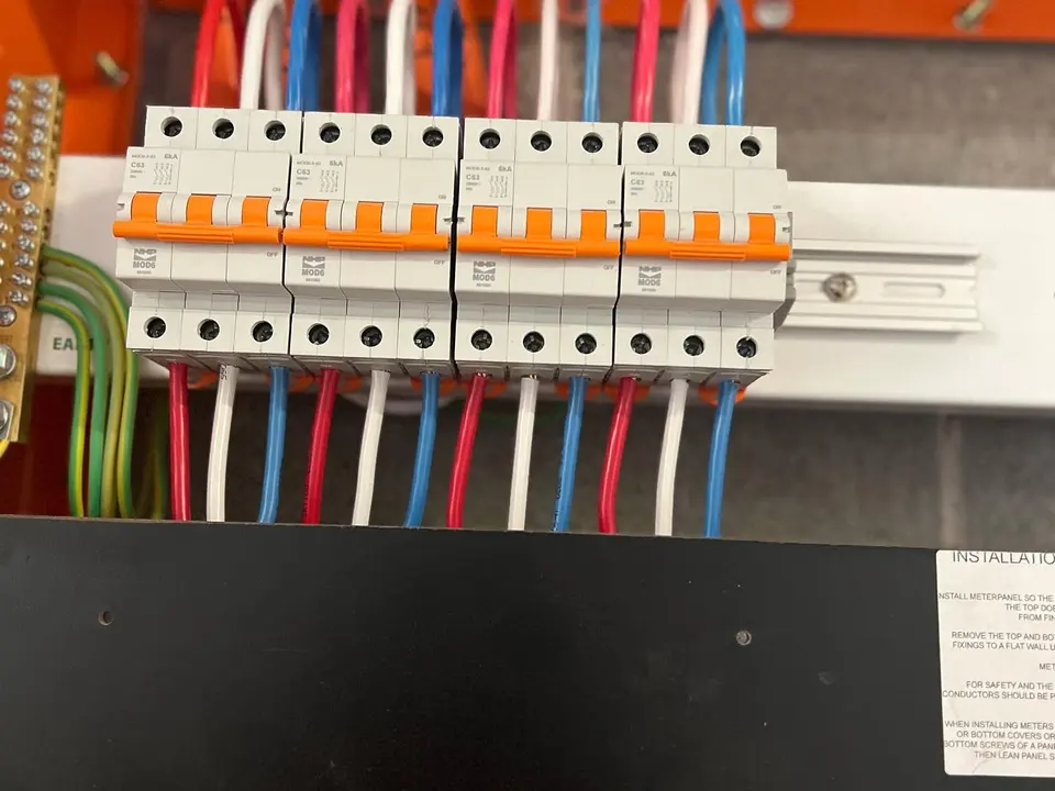 Row of circuit breakers with colour-coded wiring