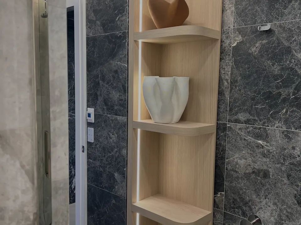 Marble wall with lit feature shelving